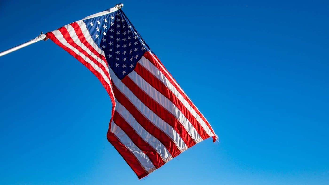 An American flag against a clear blue sky