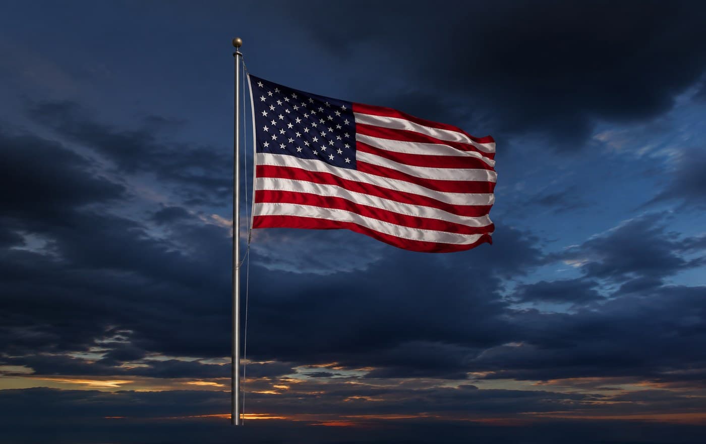 The American flag flying against a dark evening sky